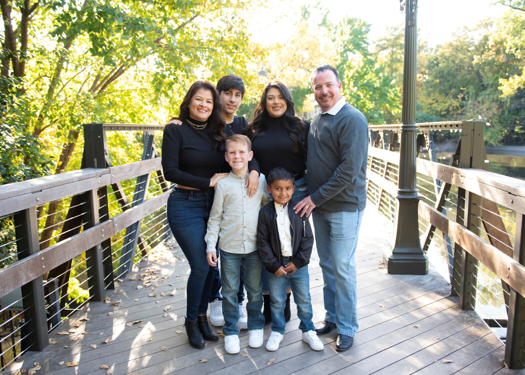 The Sidwell family poses on a bridge for family pictures.